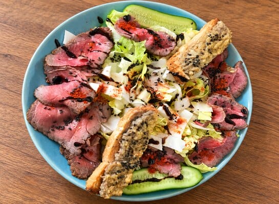 Salade composée garnie de fines tranches de rôti de bœuf froid au mélange 5 Baies de Papa